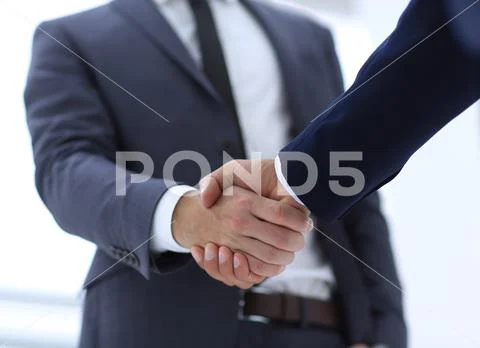 Close up of two young male business partner shake hand Stock Photos