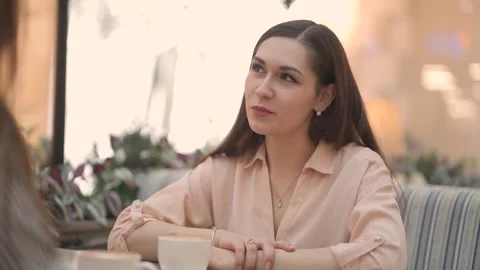 Close-up two young women talking in a cafe in a shopping center Stock Footage 144598909