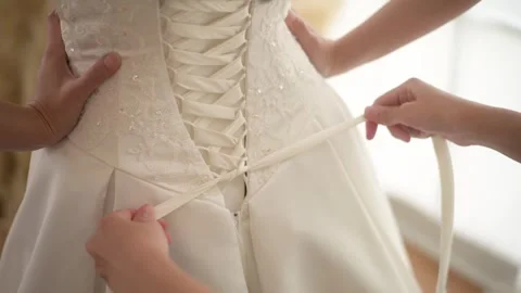 Close up of tying bow on elegant White bridal wedding dress Video stock 280206210