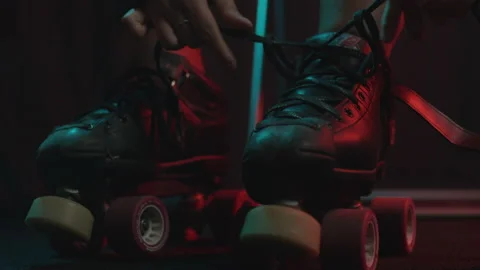 Close up tying up roller skates for derby match Stockbeeldmateriaal 233820844