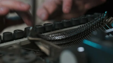 Close up typebars of old antique typewriter. Man printing something on list of Video stock 150601233