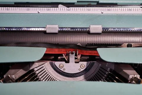 Close-up of typewriter typebars with letters and the black and red ink ribb.. Stock Photos