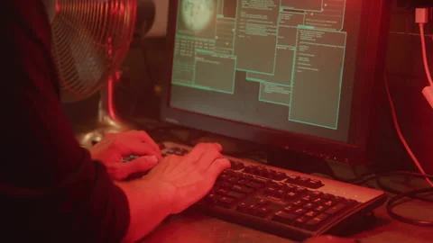 Close up of Typing on Computer Keyboard and Stealing Data in Red Basement Light Stock Footage 218464352