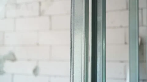 Close-up of a U profile frame against the background of an aerated concrete Stock Footage 235421770