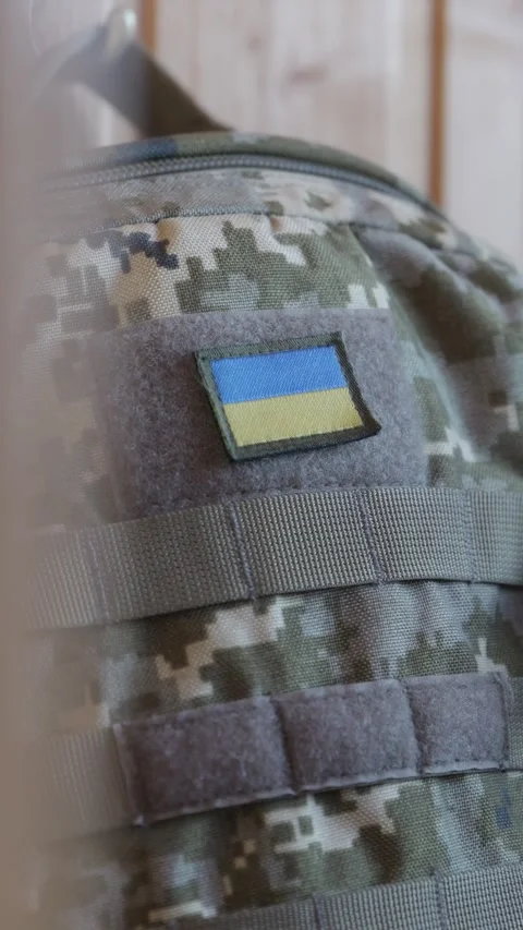 Close up of Ukrainian flag insignia patch on pixel camo backpack 스톡 동영상 346713330
