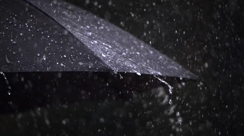 Close-up ultra-slow motion rain falling on a black umbrella Stock Footage