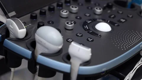 Close up of ultrasound machine control panel with multiple probes and buttons in Stock Footage 346977940