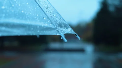Close-up of an umbrella covered by raindrops during outdoor walking in a city Stock Footage 274552118