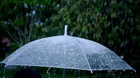 Close-up on umbrella with rain falling in slow motion shot Stock Footage 77174742