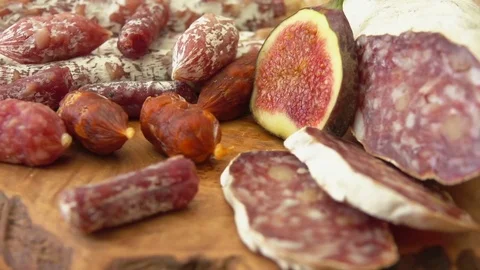 Close up uncooked jerked sausages and figs Stock Footage
