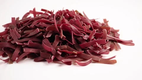 Close Up of Uncooked Red Beetroot Pasta on White Background Stock Footage 333818857