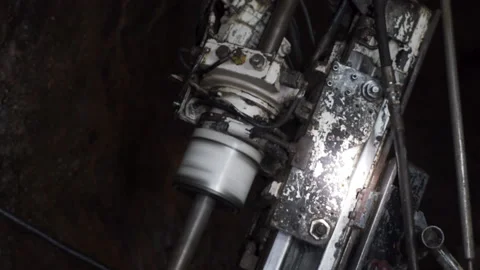 Close up. Underground mine drilling machine spinning as it excavates the Stock Footage 230869091