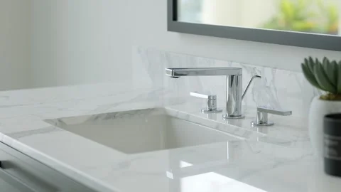 Close up of undermount ceramic washbasin and steel faucet on white marble Stock Footage 265201606