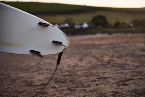 Close Up Of Underside Of Surfboard With Sandy Beach In Background Foto stock