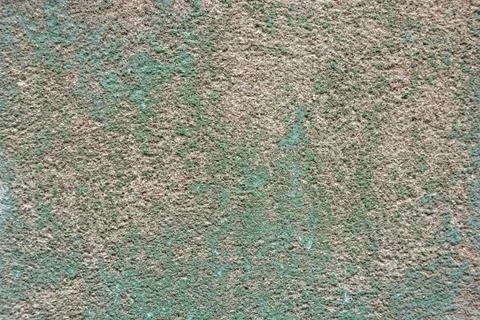 Close up uneven plaster surface with green paint Foto stock