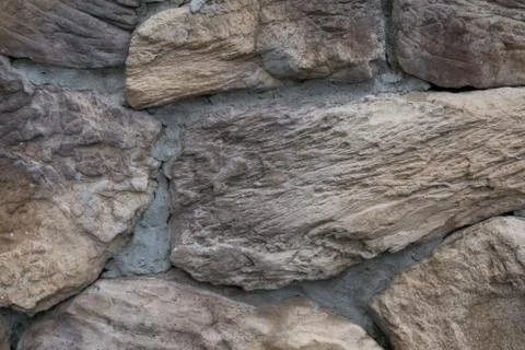 Close up uneven real stone pattern brown color of vintage style design decora Stock Photos