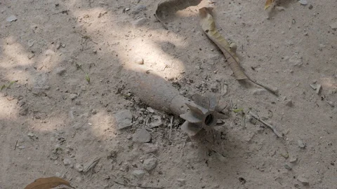 Close up of unexploded ordnance (UXO) mortar on the ground  Stock Footage 148402850