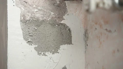 Close-up of unfinished cement wall on construction site, plasterer using metal Video stock 150024964