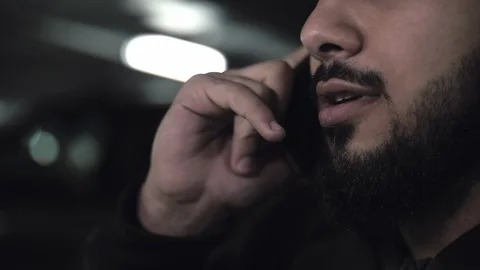 Close-up of an unidentified young man talking on a smartphone Stock Footage 112278757