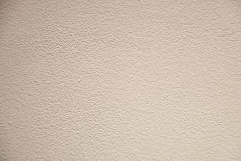 Close-up of a uniform textured pattern wall with a plaster surface. Stock Photos