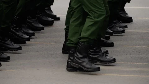 Close-up of uniformed soldiers marching in precise formation, black combat boots Video stock 317563167