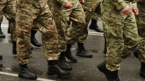 Close-up of uniformed troops in camouflage combat boots marching in formation 스톡 동영상 335262755