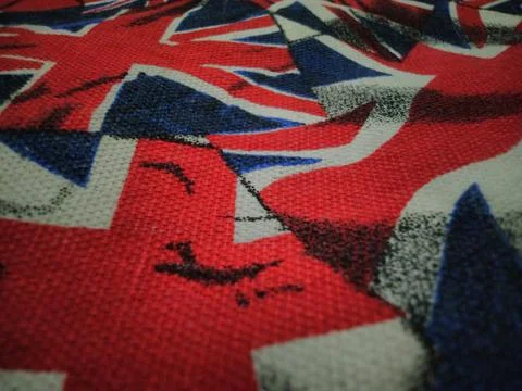 Close-up of Union Jack flag fabric pattern with red, white, and blue colors. Stock Photos