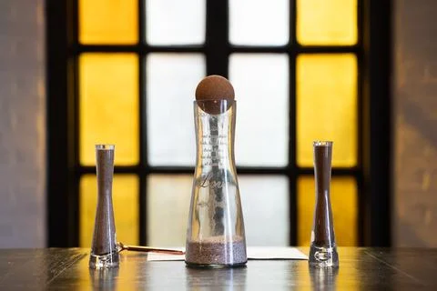Close up of unity sand ceremony setup with glass vessels and cross symbol Stock Photos