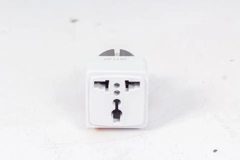 Close up of universal electric socket plug adapters, isolated on white backgr Stock Photos