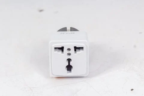 Close up of universal electric socket plug adapters, isolated on white backgr Stock Photos