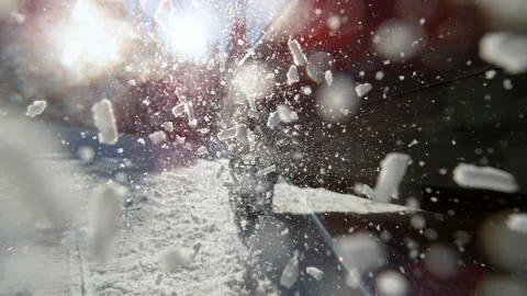 CLOSE UP: Unknown car spins its wheels while trying to get traction on snow. Stock Footage 145642119