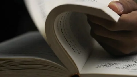 Close up of unknown man's hand turning the pages of a book Stock Footage 295944484