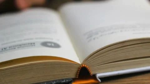 Close up of unknown man's hand turning the pages of a book Stock Footage 295944491