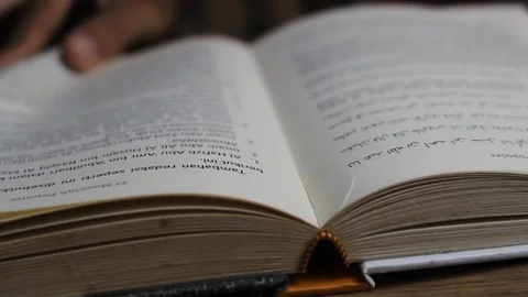 Close up of unknown man's hand turning the pages of a book Stock Footage 295944580