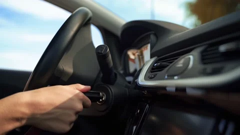 Close up of an unknown person turning on the car engine with the key. Stock Footage 218467959