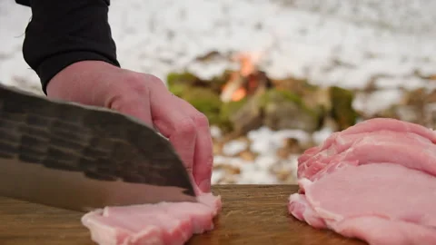 Close up of unknown young man prepares fresh meat near bonfire Stock Footage 308719059