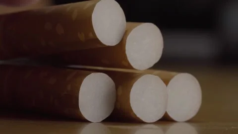 Close Up of Unlit Cigarettes Arranged in a Stack Showing White Filters and Stock Footage 347721767