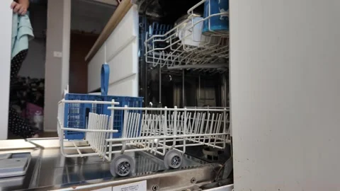 Close-up of unloading clean dishes from dishwasher in modern kitchen Stock Footage 331788224