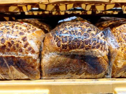 Close up of unmarked slices of bread are on a supermarket shef Stock Photos