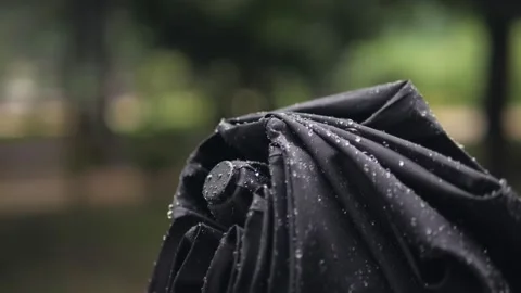 Close-up of an unopened umbrella with raindrops Stock Footage 157585687