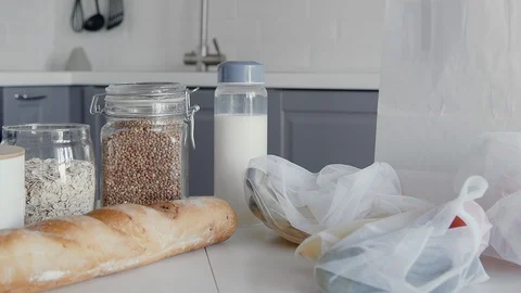 Close up of Unpacked shopping bag with bread, oatmeal, buckwheat, milk Stock Footage 127932177