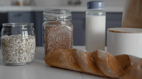 Close up of unpacked shopping bag with bread, buckwheat, oatmeal, milk Stock Footage 127947915