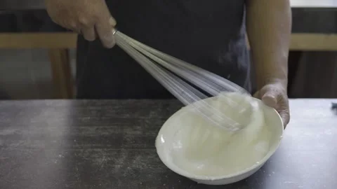 Close up of an unrecognisable baker beating egg Stock Footage 272498966
