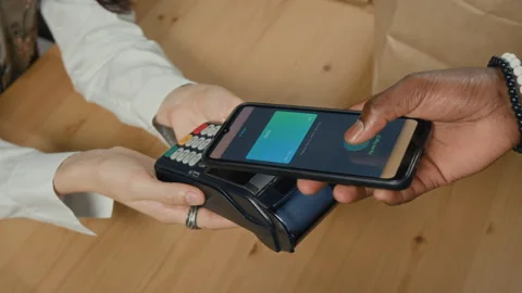 Close-up of Unrecognizable African American Man Paying with Smartphone Stock Footage 328363374