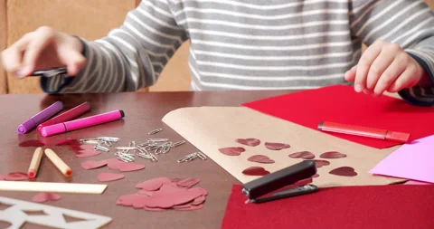 Close-up of an unrecognizable child making a handmade postcard from red hearts Stock Footage 151009912