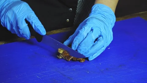 Close up of unrecognizable cook finely chopping champignon mushroom Stock Footage 99849191