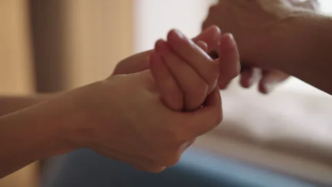 Close-up of unrecognizable couple hands gently rubbing lotion, showing Stock Footage 321291774