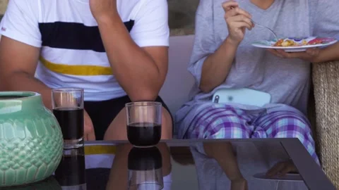Close-up of an unrecognizable couple having breakfast with black soda on the ter 库存影片 199510813