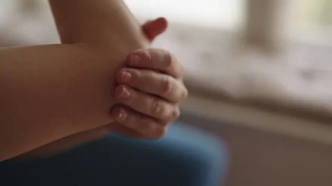Close-up of unrecognizable female applying moisturizing cream to elbow Stock Footage 323202457