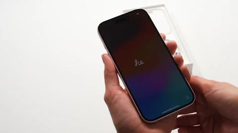 Close-up unrecognizable female hands turning on new smartphone iPhone 15 pro Stock Footage 289468913